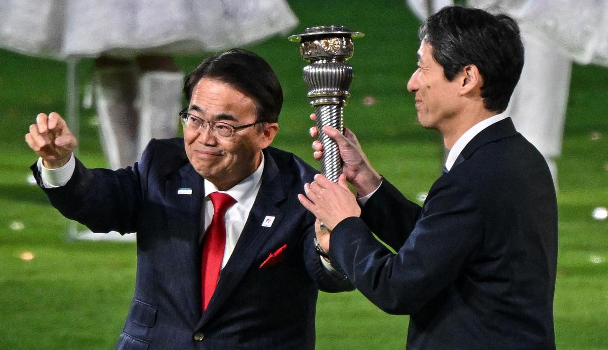 Gubernur di prefektur Aichi, Jepang, Ohmura Hideaki (kiri) dan wakil walikota Nagoya, Jepang, Nakata Hideo (kanan) mengambil bagian dalam penyerahan obor pada upacara penutupan Asian Games 2022 yang berlangsung di Hangzhou Olympic Sports Centre Stadium, Hangzhou, China pada Minggu (08/10/2023). Jepang menjadi tuan rumah Asian Games selanjutnya yang akan berlangsung pada 2026 mendatang. (AFP/Jung Yeong-je)