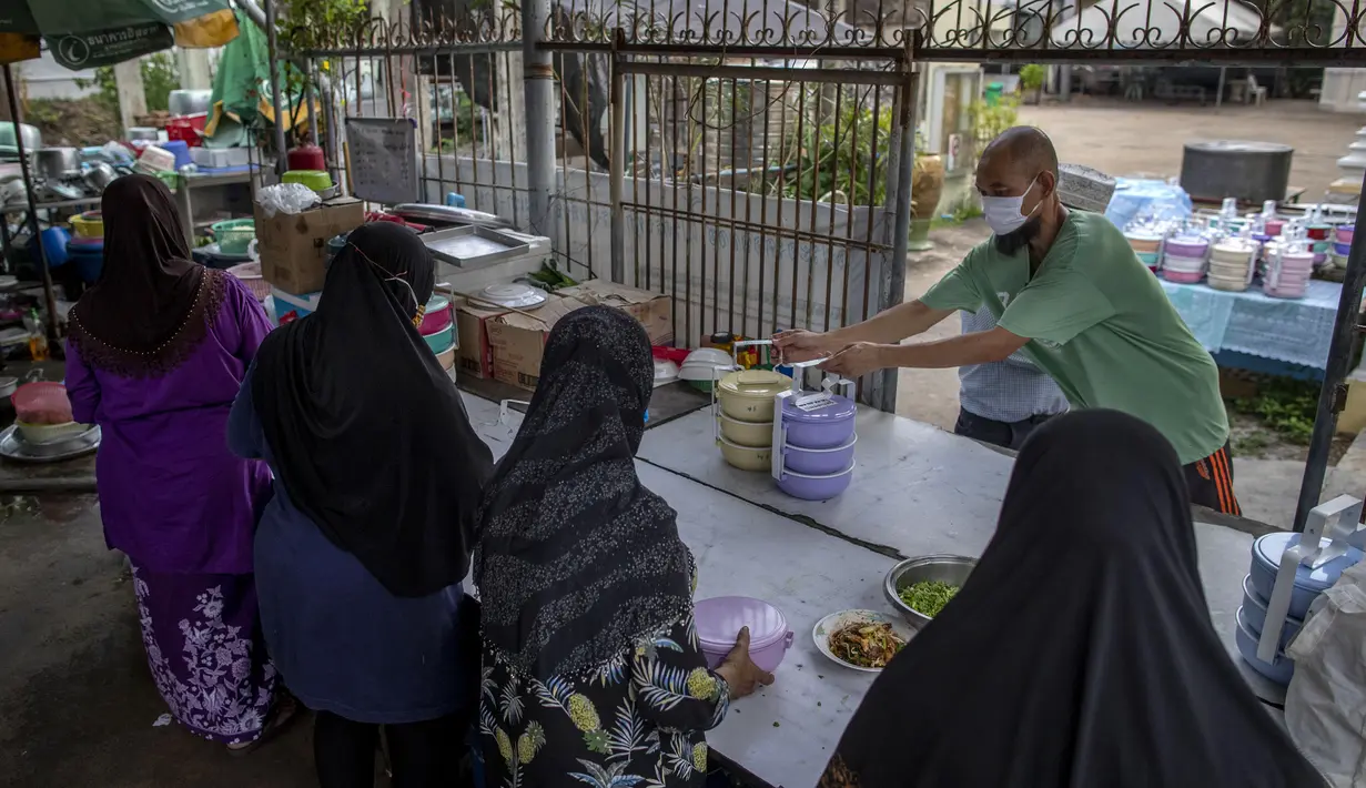 Sukarelawan menata kotak-kotak berisi makanan di Masjid Bang Aw, Bangkok, Thailand, Kamis (30/4/2020). Setiap hari selama Ramadan, sukarelawan membagikan makanan kepada 150 keluarga sekitar Masjid Bang Aw yang tidak bisa beribadah bersama karena pandemi COVID-19. (AP Photo/Gemunu Amarasinghe)