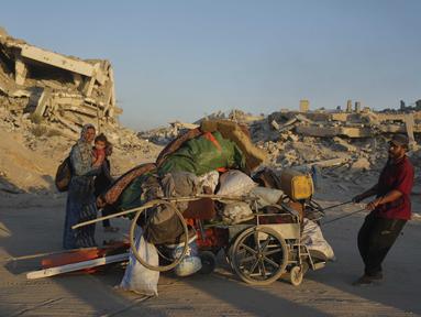 Warga Palestina yang mengungsi dari Jalur Gaza utara memindahkan barang-barang mereka di sepanjang Jalan Laut, di Kota Gaza, Senin, 1 September 2025. (AP Photo/Jehad Alshrafi)