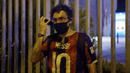Suporter memakai jersey Lionel Messi mengikuti protes di depan kantor Barcelona, Selasa (25/8/2020). Aksi tersebut merupakan respon fans atas kabar Lionel Messi yang akan meninggalkan Camp Nou pada musim panas ini. (AFP/Pau Barrena)