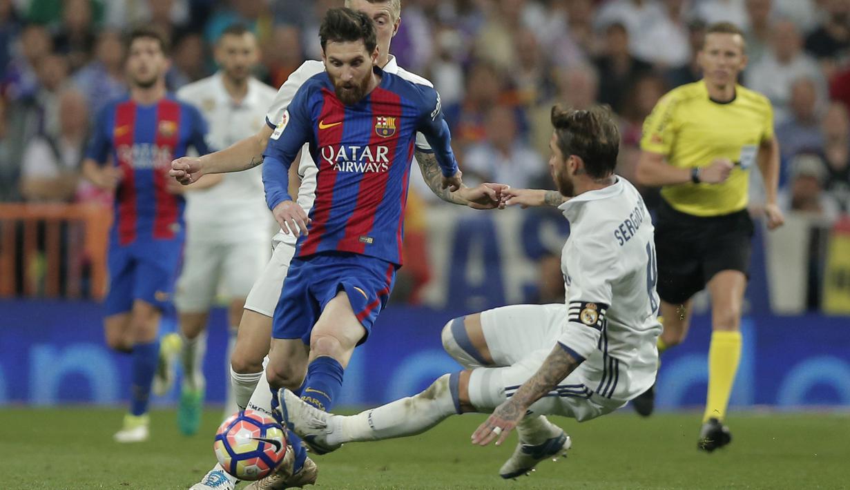 Lionel Messi mendapat adangan dari bek Real Madrid, Sergio Ramos dpada duel El Clasico di Santiago Bernabeu stadium, Madrid, Spanyol, Minggu, (23/4/2017). Barcelona menang 3-2.  (AP/Daniel Ochoa de Olza)