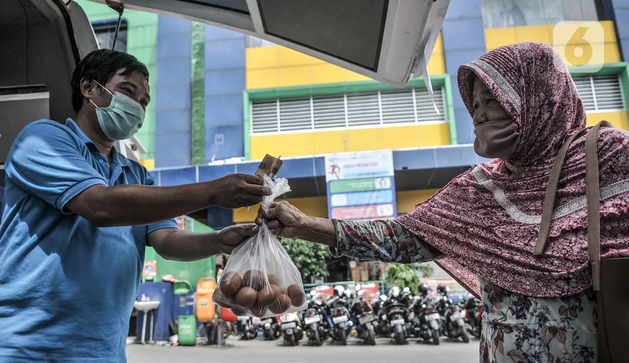 Warga saat membeli telur saat Gelar Pangan Murah di Pasar Tebet Barat, Jakarta, Rabu (23/12/2020). Pemprov DKI Jakarta bersama Badan Ketahanan Pangan Kementerian Pertanian menggelar Pangan Murah di 15 pasar tradisional mulai 23-30 Desember 2020. (merdeka.com/Iqbal S. Nugroho)