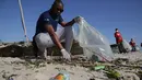 Para sukarelawan mengumpulkan sampah di sepanjang Pantai Kawe di Dar es Salaam, Tanzania (19/9/2020). Ratusan orang di seluruh kota tersebut berpartisipasi dalam upaya pembersihan sampah di pantai untuk memperingati Hari Bersih-Bersih Sedunia. (Xinhua)
