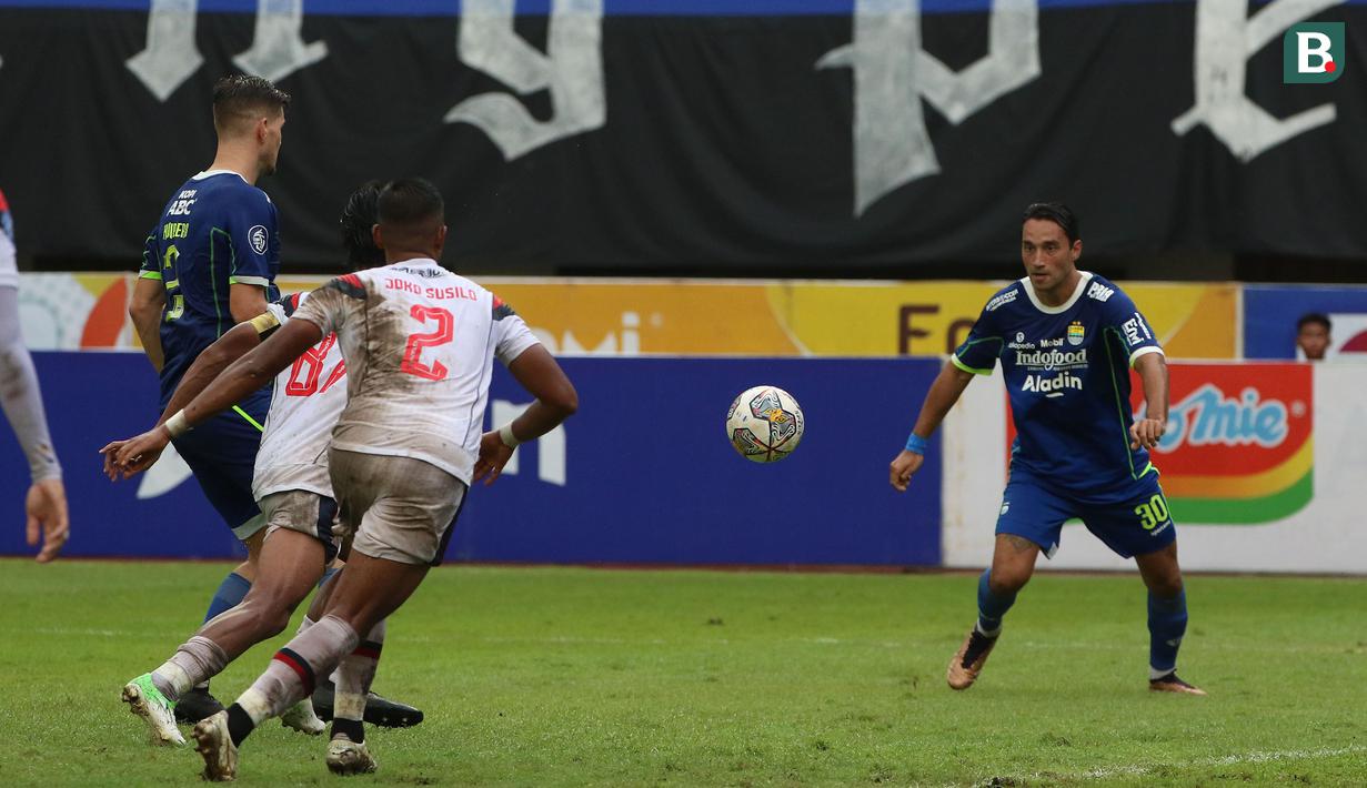 <p>Pemain Persib Bandung, Ezra Walian (kanan) berusaha menendang bola ke gawang Arema FC pada pertandingan pekan ke-26 BRI Liga 1 2022/2023 yang berlangsung di Stadion Pakansari, Bogor, Kamis (23/2/2023). (Bola.com/Ikhwan Yanuar)</p>