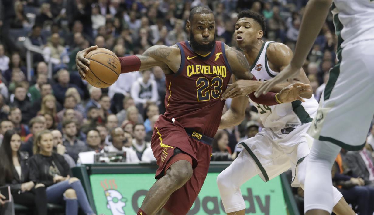 Pemain Cleveland Cavaliers, LeBron James (kiri) menggiring bola melewati adangan pemain Milwaukee Bucks, Giannis Antetokounmpo pada laga NBA basketball game di BMO Harris Bradley Center, Milwaukee, (19/12/2017). Bucks menang 119-116. (AP/Morry Gash)