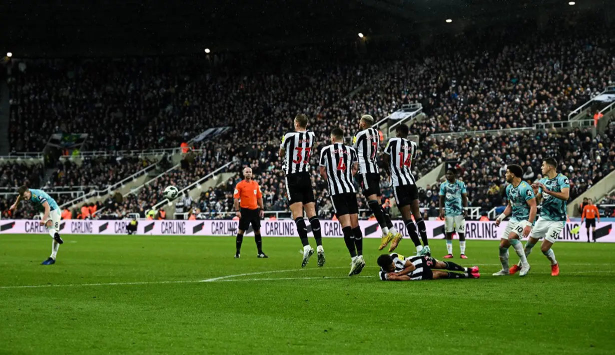 Pemain Southampton James Ward-Prowse (kiri) melakukan tendangan bebas saat melawan Newcastle United pada pertandingan sepak bola semifinal Piala Liga Inggris di Stadion St James's Park, Newcastle, Inggris, 31 Januari 2023. Newcastle United mengalahkan Southampton dengan skor 2-1 dan berhasil melenggang ke final Piala Liga Inggris. (Paul ELLIS/AFP)