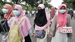 Relawan yang terdiri dari beberapa perempuan membawa kotak P3K untuk membantu para demonstran, Jakarta, Jumat (4/11). Relawan kesehatan ini siaga bantu para demonstran yang kelelahan atau sakit saat aksi demo. (Liputan6.com/Yoppy Renato)