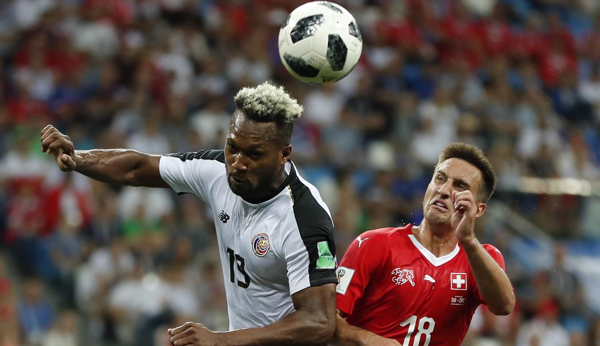 Duel pemain Kosta Rika, Rodney Wallace (kiri) dan pemain Swiss, Mario Gavranovic pada laga grup E Piala Dunia 2018 di Nizhny Novgorod Stadium, Nizhny Novgorod, Rusia, (27/6/2018). Swiss bermain imbang 2-2. (AP/Natasha Pisarenko)