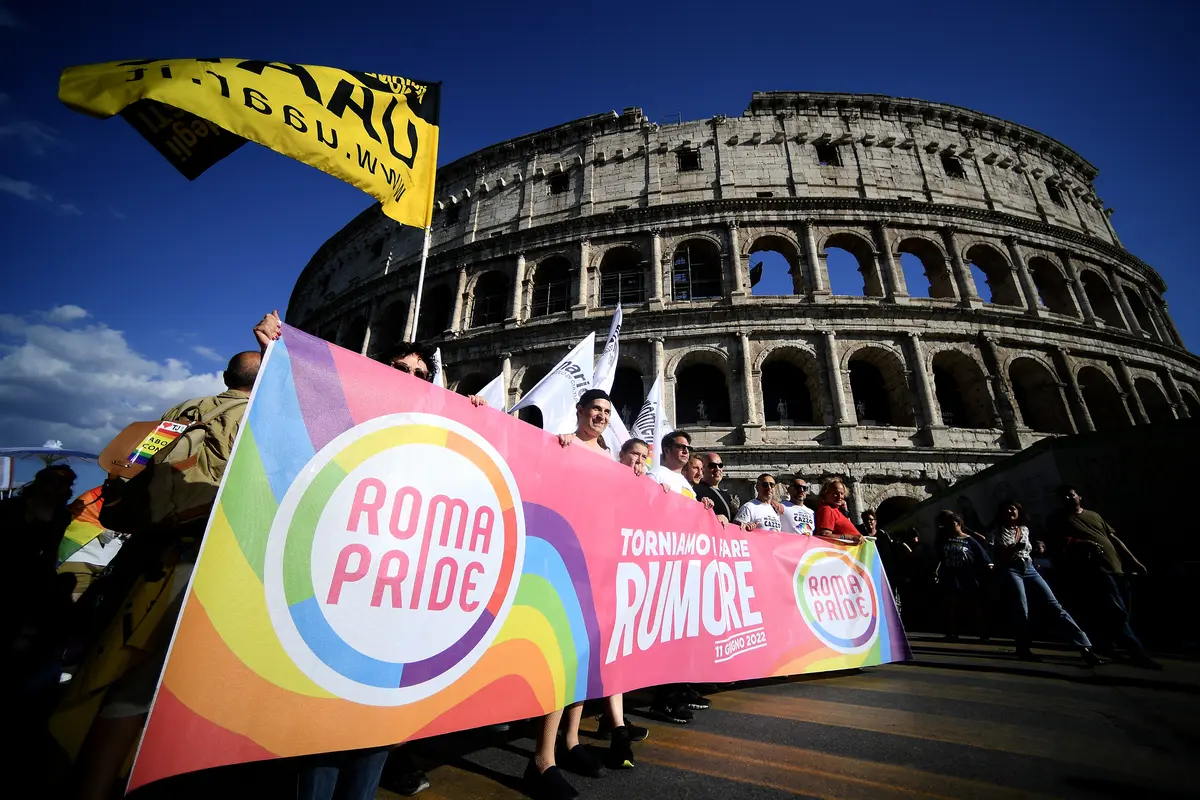 Para peserta memegang spanduk saat mengikuti Pride March tahunan di Roma, Italia pada 11 Juni 2022.