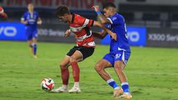 Pemain Persib Bandung, Berguinho menjaga ketat pemain Madura United pada laga pekan ke-23 BRI Super League 2025/2026 di Stadion Gelora Bandung Lautan Api (GBLA), Kota Bandung, Kamis (26/2/2026) malam WIB. (Bola.com/Erwin Snaz)