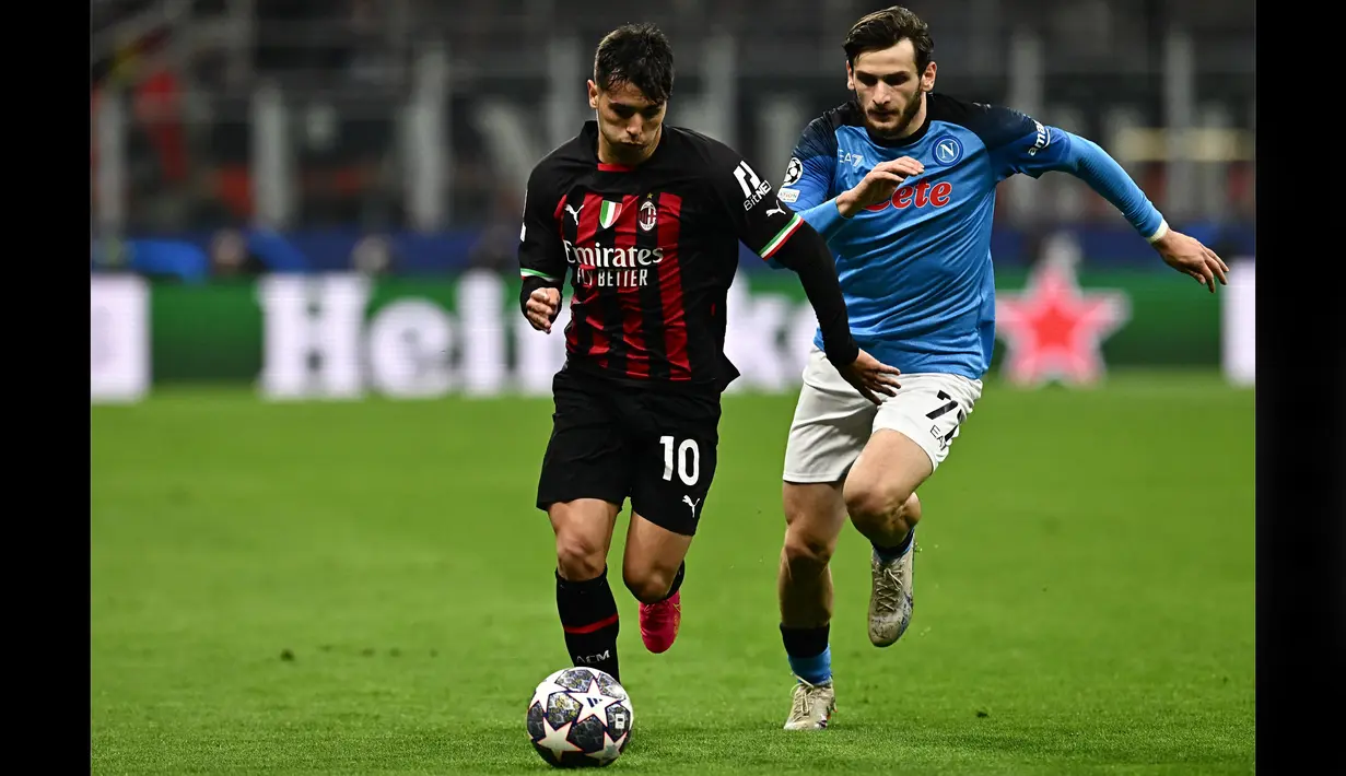 Pemain AC Milan, Brahim Diaz (kiri), berebut bola dengan pemain Napoli, Khvicha Kvaratskhelia, dalam pertandingan leg pertama perempat final Liga Champions 2022/2023 yang berlangsung di San Siro, Milan, Kamis (13/4/2023). Brahim Diaz merupakan aktor utama terciptanya gol tunggal Milan. Gelandang asal Spanyol itu melakukan solo run untuk membangun serangan balik cepat. Diaz pun tercatat sebagai pemberi assist. (AFP/Gabriel Bouys)