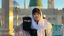 Atta Halilintar berpose bersama sang istri Aurelie Hermansyah. Atta tampak mengenakan outfit berwarna hitam-putih dengan syal yang dikenakannya di kepala, sedangkan Aurelie tampil dengan outfit berwarna cokelat, masih lengkap dengan burqa berwarna hitam. Foto: Instagram.