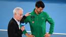 Petenis Serbia, Novak Djokovic, menangis saat diwawancara tentang Kobe Bryant seusai laga Australia Open 2020 di Melbourne, Selasa (28/1). Beri penghormatan dirinya memakai jaket inisial Kobe Bryant. (AFP/William West)