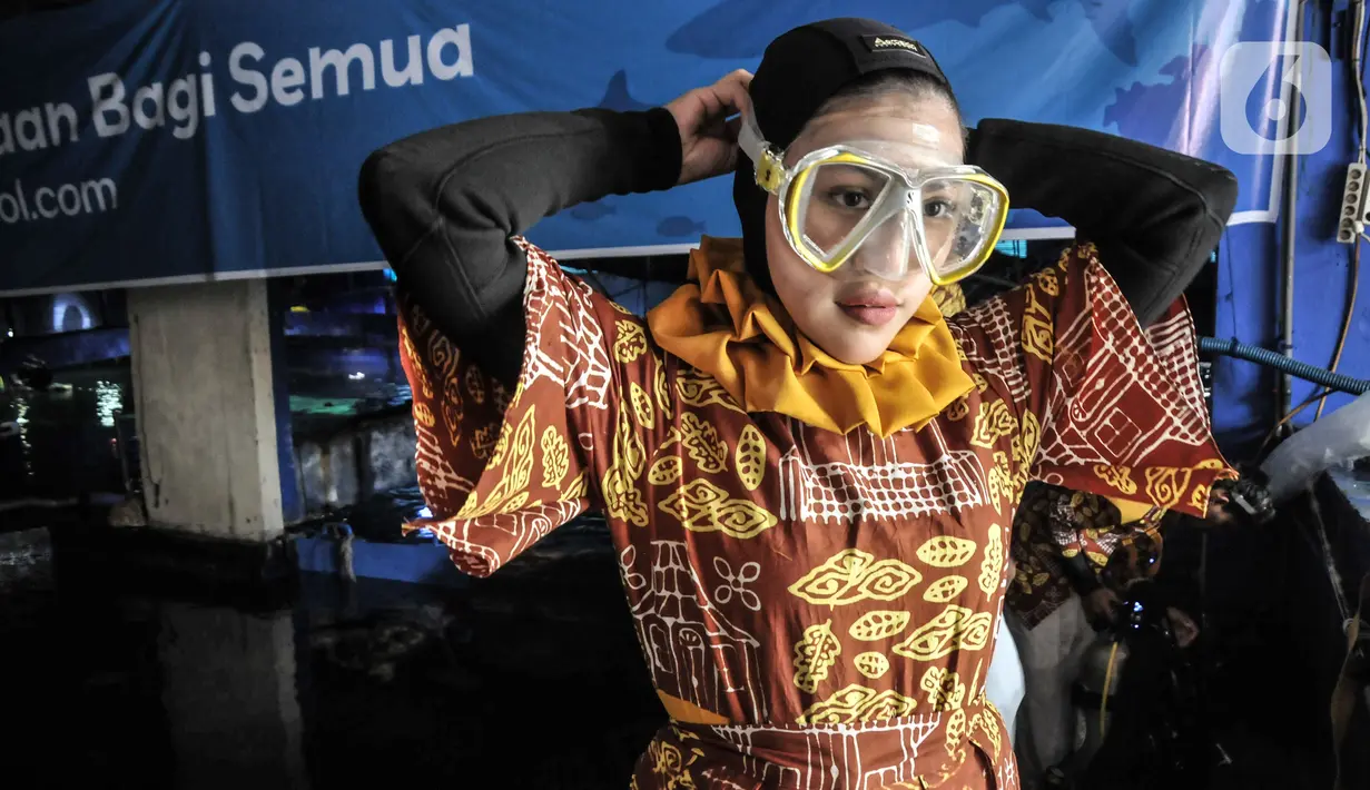 Penyelam mengenakan busana batik saat bersiap sebelum tampil untuk pertunjukan bawah air dalam rangka menyambut Hari Batik Nasional di Sea World Ancol, Jakarta Utara, Rabu (28/9/2022). Sea World Ancol menggelar pertunjukkan bertajuk "Pekan Kolaborasi Budaya dan Sejarah" untuk menyambut peringatan Hari Batik Nasional Tahun 2022 yang akan berlangsung pada tanggal 1-9 Oktober 2022 dengan menampilkan fashion show, tarian tradisional serta atraksi bawah air. (merdeka.com/Iqbal S. Nugroho)