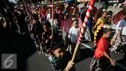 Para anak mengikuti pawai pembangunan melintasi Jalan Malioboro, Yogyakarta, Minggu, (20/8). Pawai pembagunan diselenggarakan di tiap tiap daerah setiap tahun setelah peringatan HUT RI. (Liputan6.com/Boy Harjanto)
