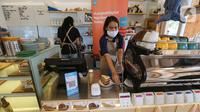 Barista membuat kopi dan melayani pembeli menggunakan teknologi Youtap di coffe shop, Gading Serpong, Tangsel, Sabtu (14/11/2020). Di tengah pandemi Covid-19, Youtap memudahkan pedagang untuk dapat memonitor penjualannya dan mencetak catatan penjualan yang akurat. (Liputan6.com/Fery Pradolo)