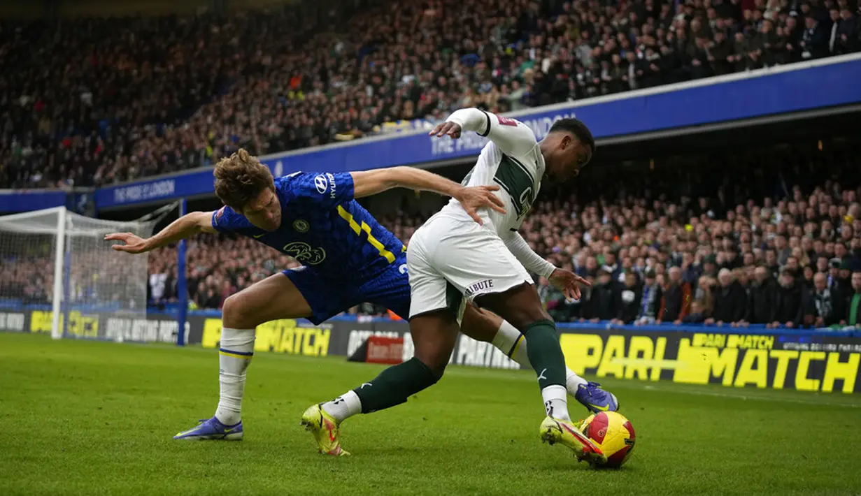 Pemain Plymouth Argyle Niall Ennis (kanan) berebut bola dengan pemain Chelsea Marcos Alonso pada putaran keempat Piala FA di Stadion Stamford Bridge, London, Inggris, 5 Februari 2022. Chelsea menang 2-1. (AP Photo/Matt Dunham)