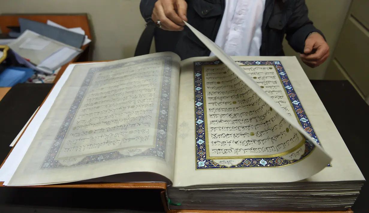 Tampilan Alquran buatan tangan yang dibuat dengan kain sutra di Mourad Khani, Kabul, Afghanistan (19/4). Alquran yang dibuat secara manual ini diharapkan dapat melestarikan tradisi kaligrafi yang telah ada berabad-abad di Afghanistan. (AFP/Wakil Kohsar)