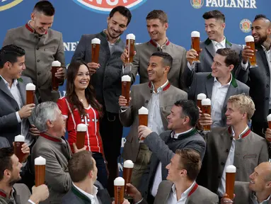 Seorang fans wanita bersama para pemain Bayern Munchen saat melakukan pemotretan sebuah perusahaan bir di Munich, Jerman, (13/9). Saat acara ini penyerang Thomas Mueller merayakan ulang tahunnya yang ke 28. (AP Photo / Matthias Schrader)