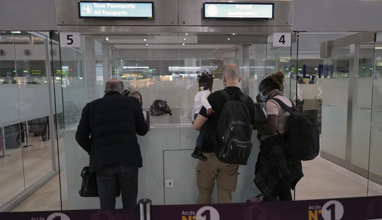 <p>Penumpang diperiksa petugas polisi sebelum menaiki pesawat di Bandara Paris Charles de Gaulle di Roissy, Paris, Senin (1/2/2021). Prancis telah menutup perbatasannya untuk mayoritas negara non-Uni Eropa akibat situasi pandemi dan kekhawatiran penyebaran varian baru Covid-19. (AP Photo/Francois Mori)</p>