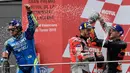 Pebalap Ducati, Andrea Dovizioso (tengah), pebalap Suzuki, Alex Rins dan pebalap Red Bull, Pol Espargaro merayakan kemenangan di podium usai balapan MotoGP Grand Prix Valencia di arena balap Ricardo Tormo, Cheste, Minggu (18/11). (Javier Soriano/AFP)