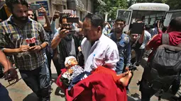 Seorang gadis yang terluka dibawa kerumah sakit setelah bus yang dinaikinya terjun ke jurang di wilayah Kishtwar di negara bagian Jammu dan Kashmir (1/7/2019). Insiden tersebut merupakan yang kedua dalam kurun waktu sepekan. (AP Photo/Channi Anand)
