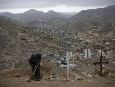 Pekerja menggali makam untuk korban COVID-19 di Pemakaman Nueva Esperanza, Lima, Peru, Minggu (1/11/2020). Untuk membantu mencegah penyebaran COVID-19, pihak berwenang menutup semua pemakaman secara nasional selama perayaan Day of the Dead. (AP Photo/Rodrigo Abd)