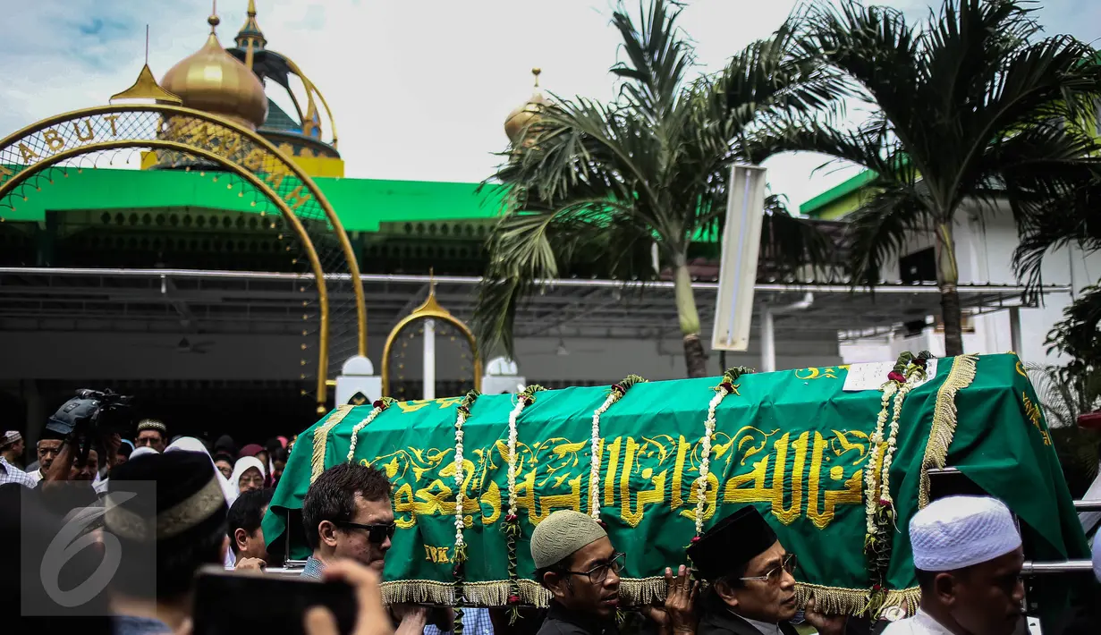 Warga dan kerabat menggotong keranda jenazah korban pembunuhan sadis Pulomas usai disalatkan di Masjid At Taubah, Pulomas, Kayuputih, Jakarta, Rabu (28/12). Tiga jenazah akan dibawa menuju TPU Tanah Kusir untuk dimakamkan. (Liputan6.com/Faizal Fanani)