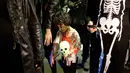 Seorang bocah mengenakan kostum zombie saat mengikuti Zombie Walk dalam Festival Purim di Tel Aviv, Israel (3/3). Purim merupakan hari raya atau pesta Yahudi untuk memperingati pembebasan kaum Yahudi dari kekaisaran Persia. (AP Photo/Ariel Schalit)