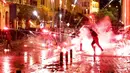 Demonstran antipemerintah melemparkan petasan ke arah polisi antihuru-hara saat demonstrasi menentang pemerintahan baru di dekat Parliament Square, Beirut, Lebanon, Rabu (22/1/2020). Demonstrasi dan kekerasan terus berlanjut kendati Lebanon telah mengumumkan kabinet baru. (AP Photo/Hussein Malla)