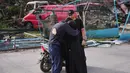 Suasana haru menyelimuti pengungsi yang kembali ke rumah-rumah mereka. Tampak dalam foto, warga setempat berpelukan di Jibchit, Lebanon selatan, Jumat 17 April 2026, setelah gencatan senjata antara Israel dan Hizbullah. (AP Photo/Hassan Ammar)