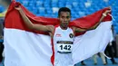 Pelari Indonesia Rikki Marthin Luther Simbolon merayakan kemenangannya pada final 10.000 m putra SEA Games 2023 di Phnom Penh, Kamboja, Kamis (11/5/2023). Rikki Marthin memenangkan pertandingan dengan catatan waktu 31 menit 8,85 detik. (MOHD RASFAN/AFP)