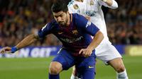 Pemain Barcelona, Luis Suarez dan pemain Real Madrid, Cristiano Ronaldo berebut bola pada pertandingan La Liga Spanyol di Stadion Camp Nou, Minggu (6/5). Real Madrid yang bermain dengan 11 pemain gagal mengalahkan 10 pemain Barcelona (AP/Emilio Morenatti)