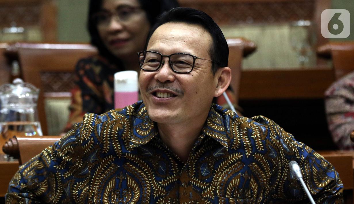 Dirut BPJS Kesehatan Fachmi Idris tertawa saat rapat dengar pendapat dengan Komisi IX DPR di Kompleks Parlemen, Jakarta, Selasa (5/11/2019). Rapat membahas polemik kenaikan iuran BPJS Kesehatan. (Liputan6.com/JohanTallo)