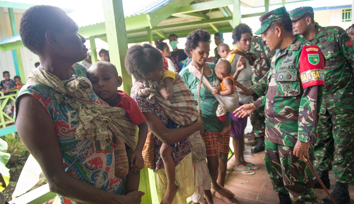 Komandan satuan tugas medis angkatan darat Indonesia Asep Setia Gunawan (kanan) mengunjungi sebuah klinik lokal di desa Ayam, distrik Asmat, di provinsi Papua Barat (26/1). (AFP/Bay Ismoyo)