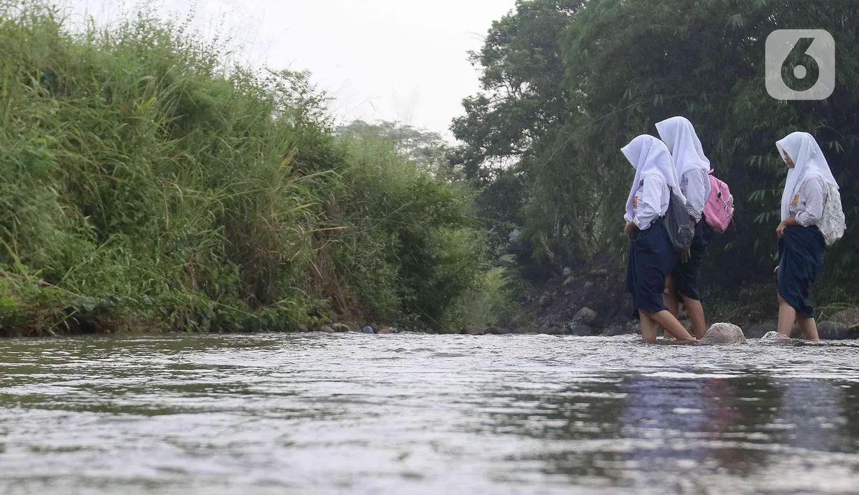 Dan, ketika hujan deras dan Sungai Cihideung meluap, para siswa terpaksa harus mengurungkan niat untuk berangkat ke sekolah. (Liputan6.com/Herman Zakharia)
