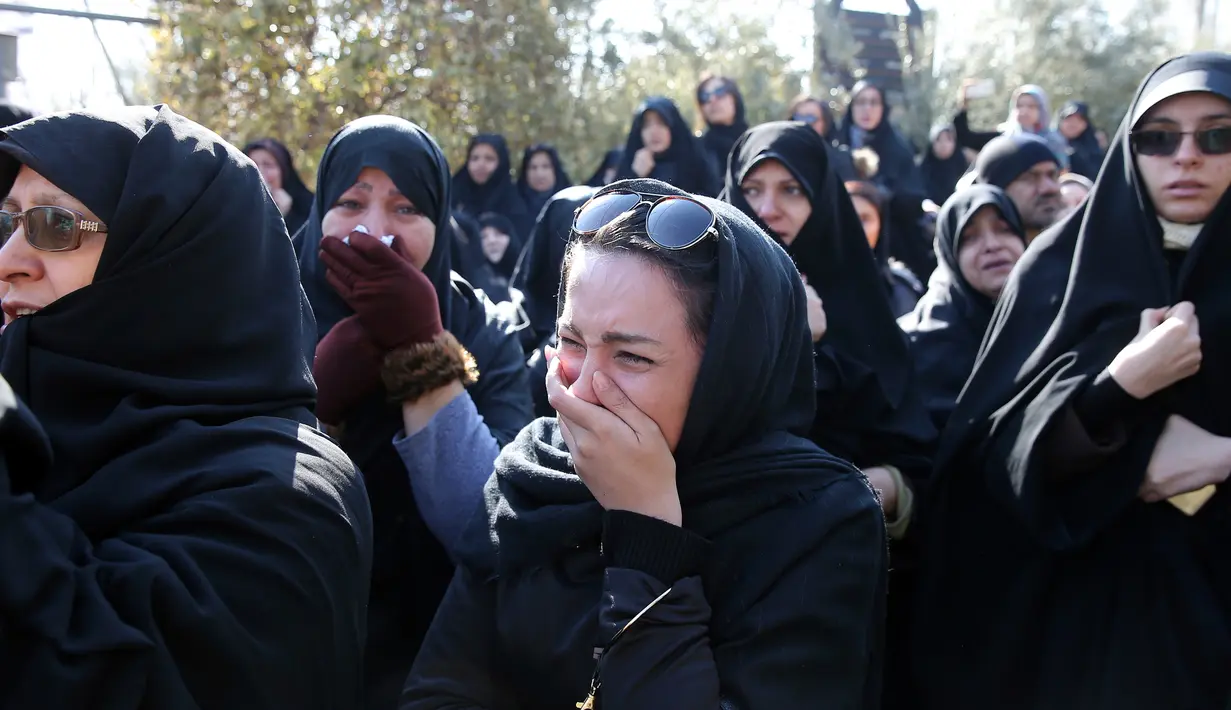 Sejumlah wanita menangis saat mengiringi jenazah untuk 16 petugas pemadam kebakaran yang tewas dalam runtuhnya gedung yang terbakar pada 19 Januari, di Teheran, Iran, Senin (30/1). (AP Photo / Ebrahim Noroozi)