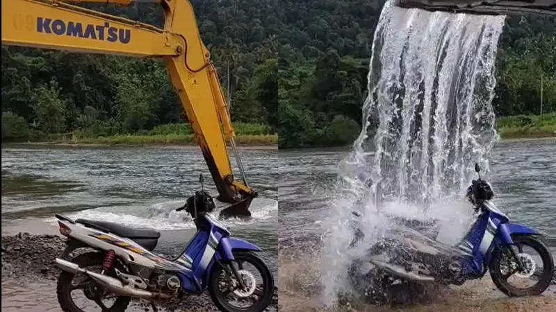 Mencuci motor pakai kendaraan alat berat