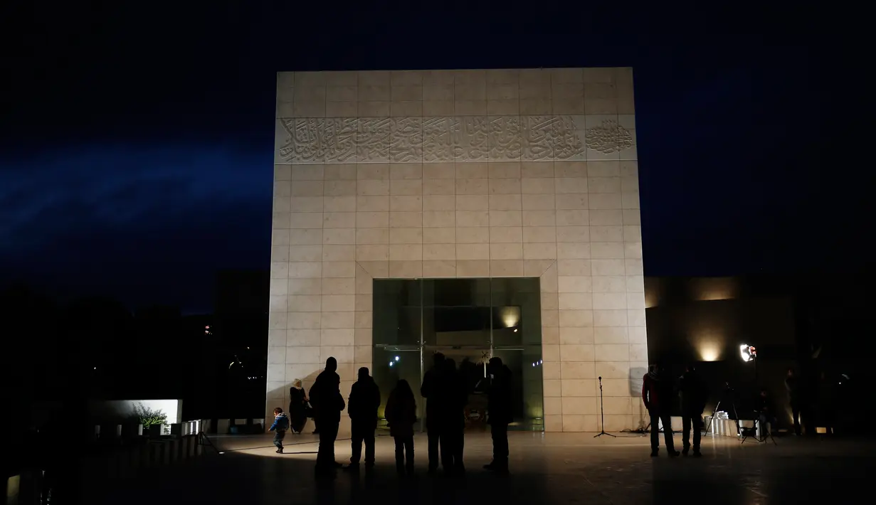 Warga Palestina mengunjungi makam mantan Presiden Yasser Arafat menjelang peringatan 11 tahun kematiannya, di Ramallah, Tepi Barat, Selasa (10/11) malam waktu setempat. (AFP PHOTO / ABBAS Momani)