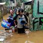 Warga menerjang banjir di RT 05/08, Pejaten Timur, Jakarta Selatan, Senin (10/10/2022) Puluhan RT di DKI Jakarta tergenang banjir akibat luapan Sungai Ciliwung yang terjadi pada dini hari tadi. (merdeka.com/Arie Basuki)