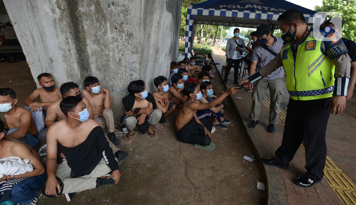 Petugas kepolisian mengamankan sejumlah orang yang diduga akan melakukan unjuk rasa di Kawasan Senayan, Jakarta, Kamis (8/10/2020). Mereka diduga hendak unjuk rasa menolak Undang-Undang Omnibuslaw Cipta Kerja di Gedung DPR. (merdeka.com/Imam Buhori)