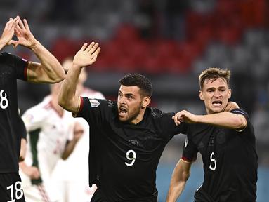 Timnas Jerman memastikan satu tempat di babak 16 besar Euro 2020 dengan dramatis. Mereka menduduki posisi kedua dalam Grup F usai bermain imbang 2-2 melawan Hungaria. (Foto: AP/Pool/Lukas Barth)