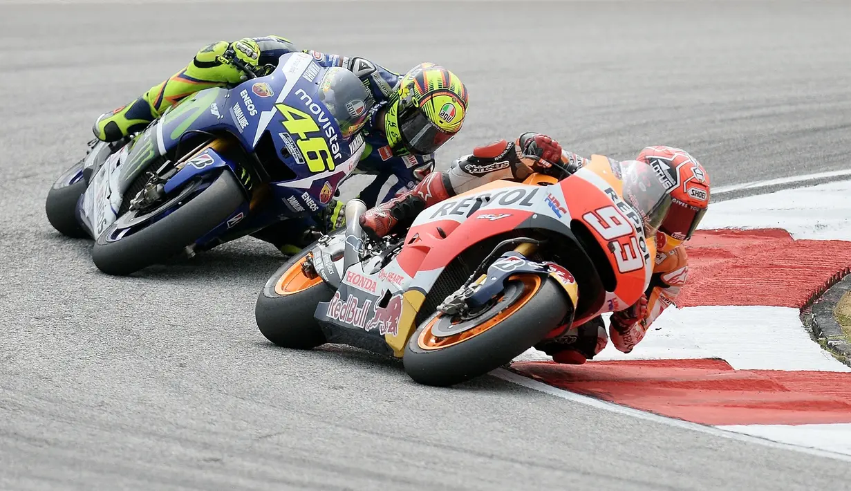 MotoGP Malaysia 2015 yang berlangsung di Sirkuit Sepangmenjadi duel paling panas antara Marquez dan Rossi. Pasalnya, Rossi melakukan gerakan kaki yang membuat Marquez terjatuh. Hasilnya, Rossi diganjar penalti start dari urutan terakhir dan gagal menjadi juara dunia MotoGP 2015. (AFP/Manan Vatsyaya)