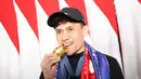 <p>Veddriq Leonardo menggigit medali emas Olimpiade Paris 2024 usai tiba di Bandara Internasional Soekarno-Hatta, Tangerang, Selasa (13/08/2024). (Abdul Aziz/Bola.com)</p>