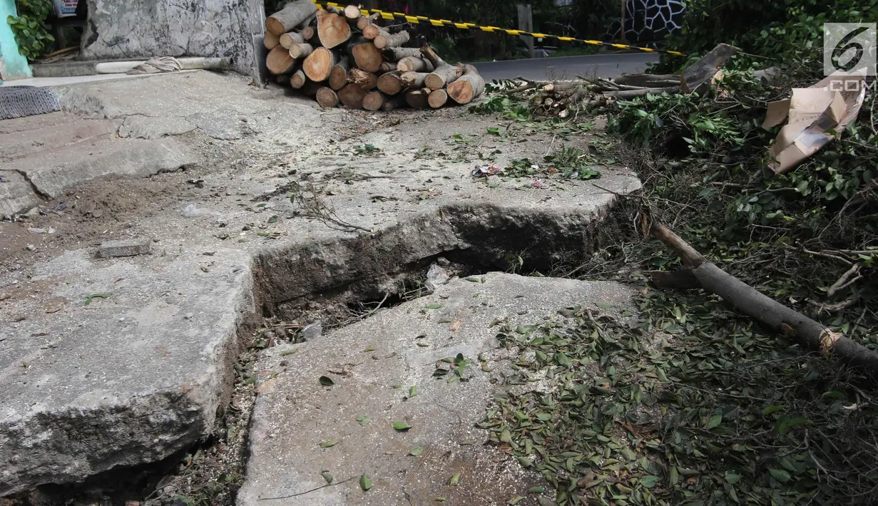 Jalan yang ambles di Jalan Al-Mujahidin, Cipinang, Pulogadung, Jakarta Timur, Rabu (21/2). Jalan tersebut ambles karena tidak kuat menahan beban truk besar yang sering melintas di jalan tersebut. (Liputan6.com/Arya Manggala)