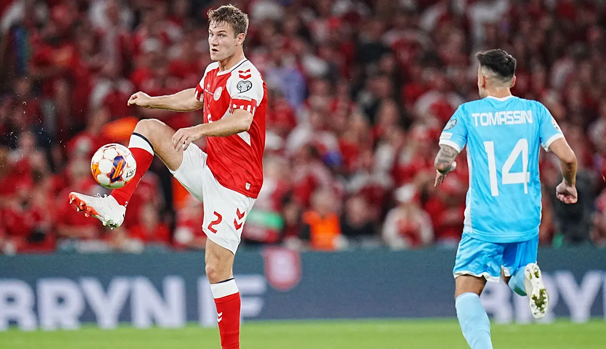 Bek Timnas Denmark, Joachim Andersen (kiri) mengontrol bola di depan striker San Marino, Fabio Tomassini pada laga matchday kelima Grup H Kualifikasi Euro 2024 di Copenhagen, Denmark, Jumat (8/9/2023) dini hari WIB. (AFP/Ritzau Scanpix/Liselotte Sabroe)