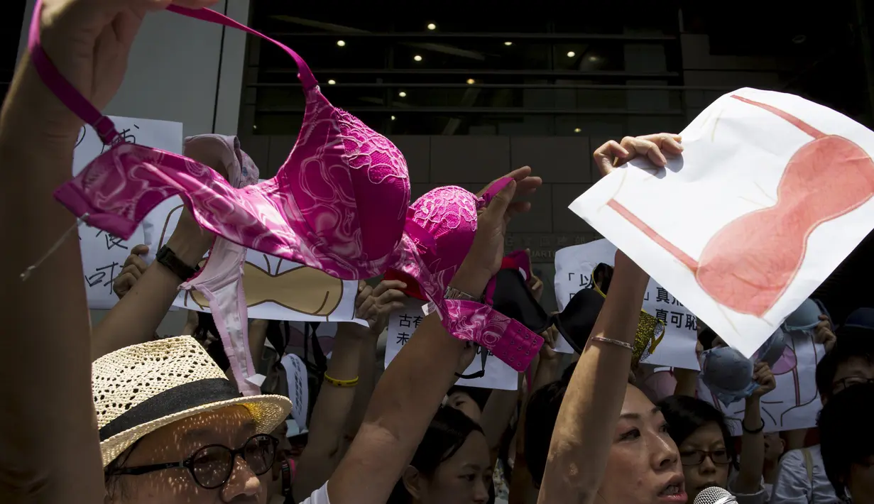 Pengunjuk rasa membawa bra di luar markas polisi di kawasan Wan Chai, Hong Kong, Minggu (2/8). Demo tersebut merupakan aksi simpati terhadap seorang perempuan yang di penjara karena dituduh menyerang polisi menggunakan payudaranya. (REUTERS/Tyrone Siu)