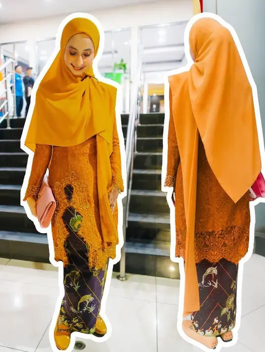 Avi memilih tampil cerah dengan outfitnya. Mengenakan kebaya panjang orange memiliki aksen slit warna orange senada dengan kerudung panjang polos. [@official_amteam]