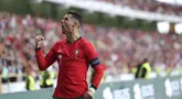 Penyerang Portugal Cristiano Ronaldo merayakan gol yang dicetaknya ke gawang Irlandia pada laga persahabatan internasional terakhir sebelum final Euro 2024 di Stadion Municipal de Aveiro, Rabu (12/6/2024) dini hari WIB.  (Foto AP/Luis Vieira)