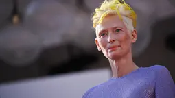 Tilda Swinton berpose untuk fotografer saat tiba untuk pemutaran film "The Eternal Daughter" selama Venice Film Festival 2022 ke-79 di di Lido di Venesia, Italia (6/9/2022). Aktris berusia 61 tahun itu  mengambil alih karpet merah dalam gaun lavender yang mempesona. (AFP/Tiziana Fabi)